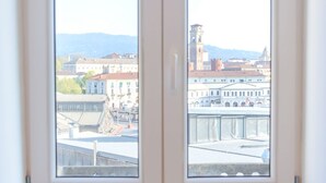 A view through a window of a cityscape with buildings and a tower. - Balon Turin View (Airco, Centrale)  (Torino)