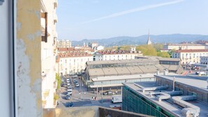 A cityscape with a mix of modern and traditional buildings, a prominent tower, and a clear sky. - Balon Turin View (Airco, Centrale)  (Torino)