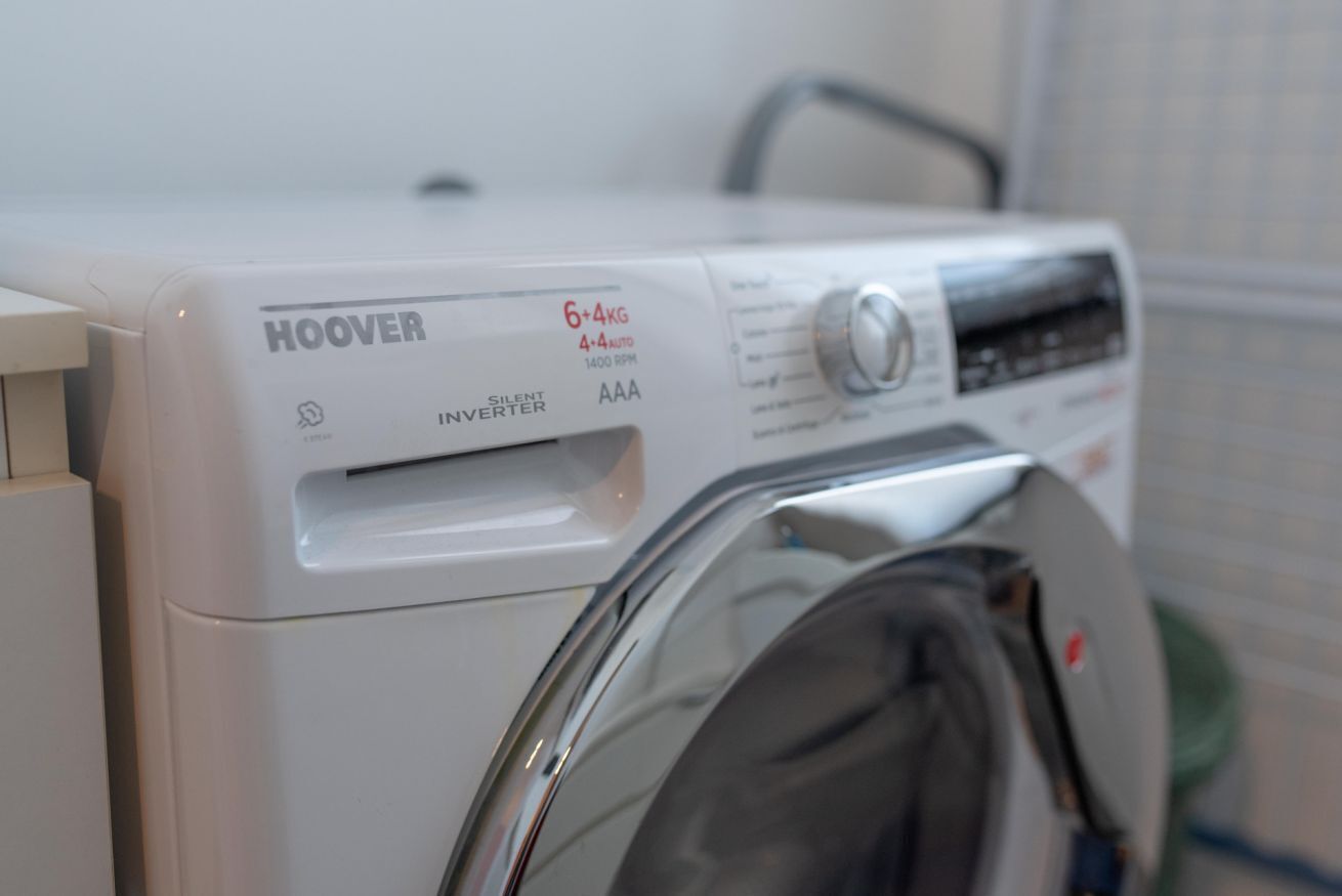 A white washing machine with a control panel and a front door.
