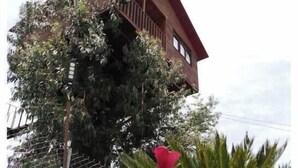 A building with a sloped roof and a balcony.