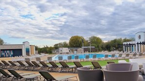 A poolside area with lounge chairs and a swimming pool.