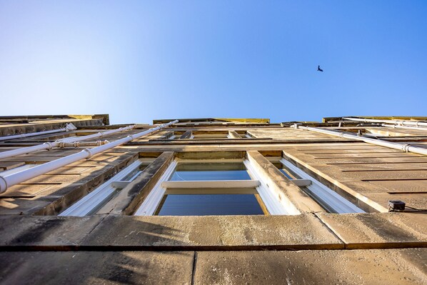 A view of a building's roof with skylights and pipes.