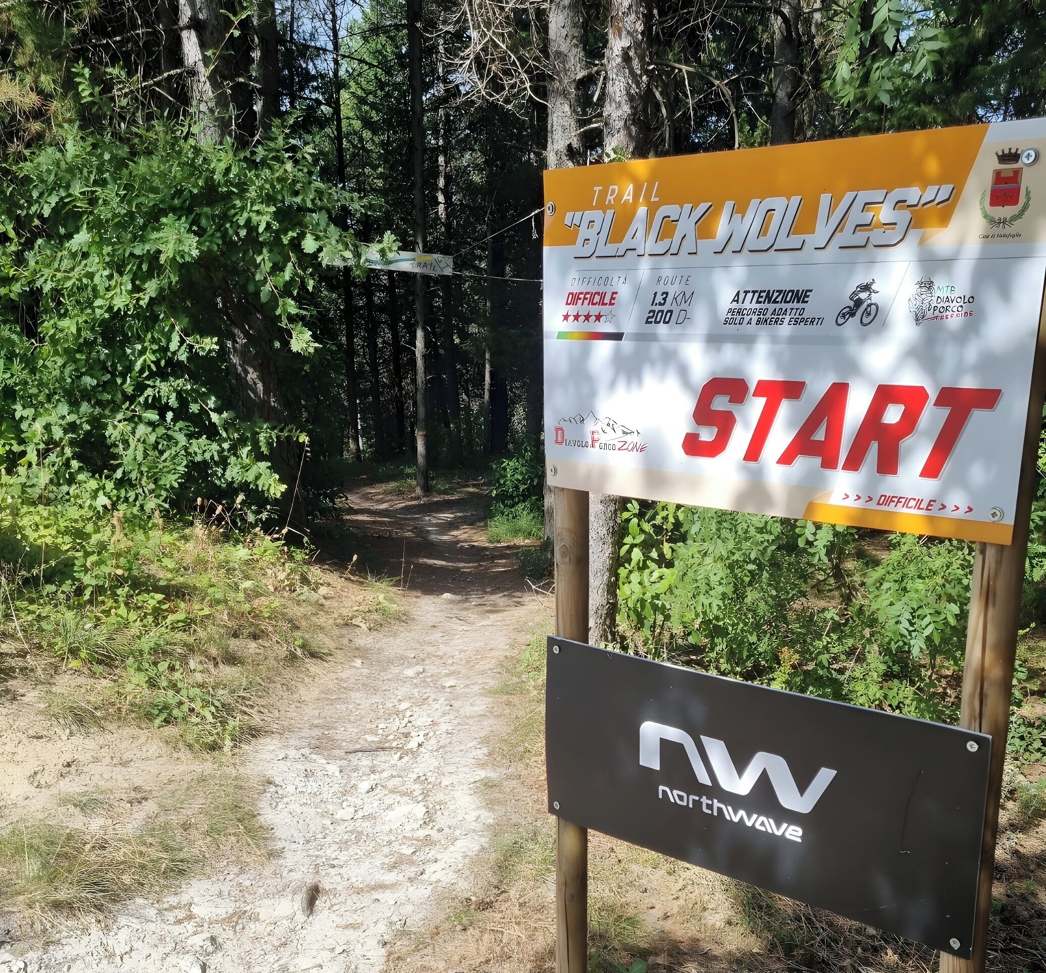 A trail sign for 'Black Wolves' with a 'START' sign below it.