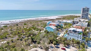 A coastal area with a beach, buildings, and a tall hotel. - Siesta Beachfront Paradise - Infinity Pool & Spa! (Sarasota)