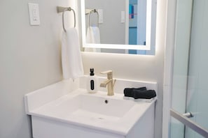 Shower, hair dryer, towels, soap