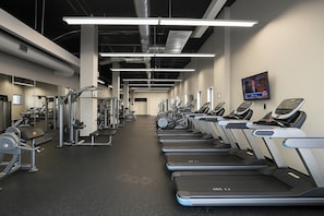 A gym with treadmills, weight machines, and a TV on the wall. - Lake View Dwntwn Stadium, Casino, Rock Hall, CSU (Cleveland)