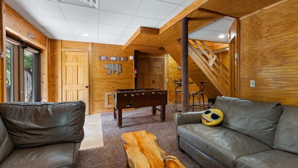 A cozy room with a foosball table, leather sofas, and a wooden coffee table. - Beartastic Outlook | Hocking Hills, Hot Tub (Rockbridge)