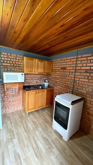 Cabin | Private kitchen | Fridge, microwave, cookware/dishes/utensils