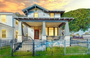 A two-story house with a covered porch and a fenced yard. - Massive Porch Paradise - 5 mins to DT (Jacksonville)