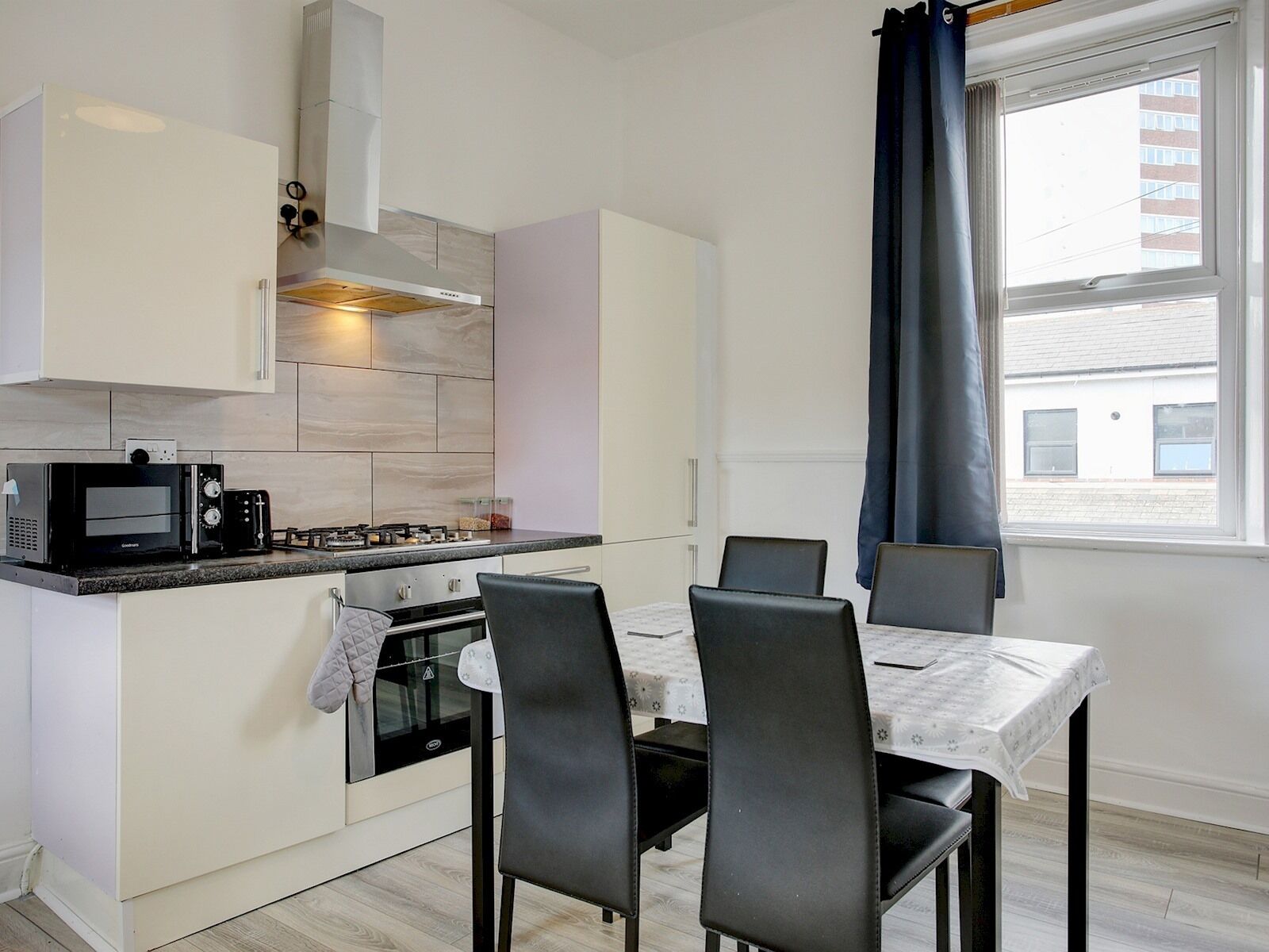 Fridge, microwave, toaster, dining tables