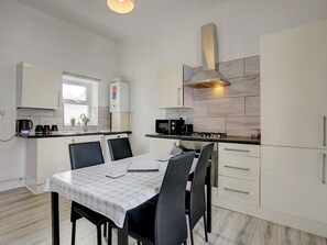 Fridge, microwave, toaster, dining tables