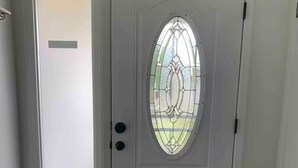 A white door with a frosted glass panel and a decorative glass window. - Free RV parking, two car garage, fenced backyard, minutes to Westgate (Glendale)