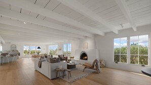 A spacious living room with a fireplace, large windows, and a wooden floor. - Gorgeous Newly Renovated Luxury Home Located 1 mile to Plaza Avail May 23- Aug 7 (Santa Fe)