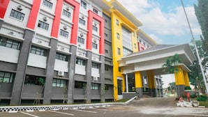A multi-story building with a modern architectural design, featuring a series of windows and air conditioning units. - Hotel Bumi Siliwangi by My Hospitality (Sukasari)