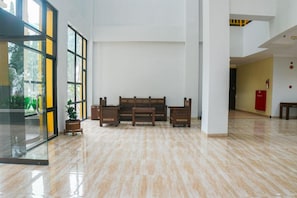 A spacious lobby with a polished marble floor, a central seating area with benches, and large windows allowing natural light. - Hotel Bumi Siliwangi by My Hospitality (Sukasari)