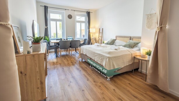 Un dormitorio con cama, escritorio, sillas y ventana.