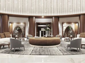 A modern lobby with a central seating area, a reception desk, and a decorative plant arrangement. - Conrad Private Residence | Ocean & Intracoastal Views | 2 Queens (Fort Lauderdale)