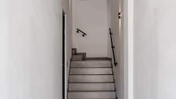 A modern staircase with a minimalist design, leading to an upper floor.