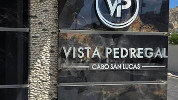 A sign for Vista Pedregal with a logo, indicating a property or hotel.