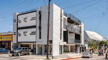 A multi-story building with commercial spaces on the ground floor, including a visible storefront.