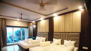 A hotel room with two beds, a large window with a view, and a marble floor.