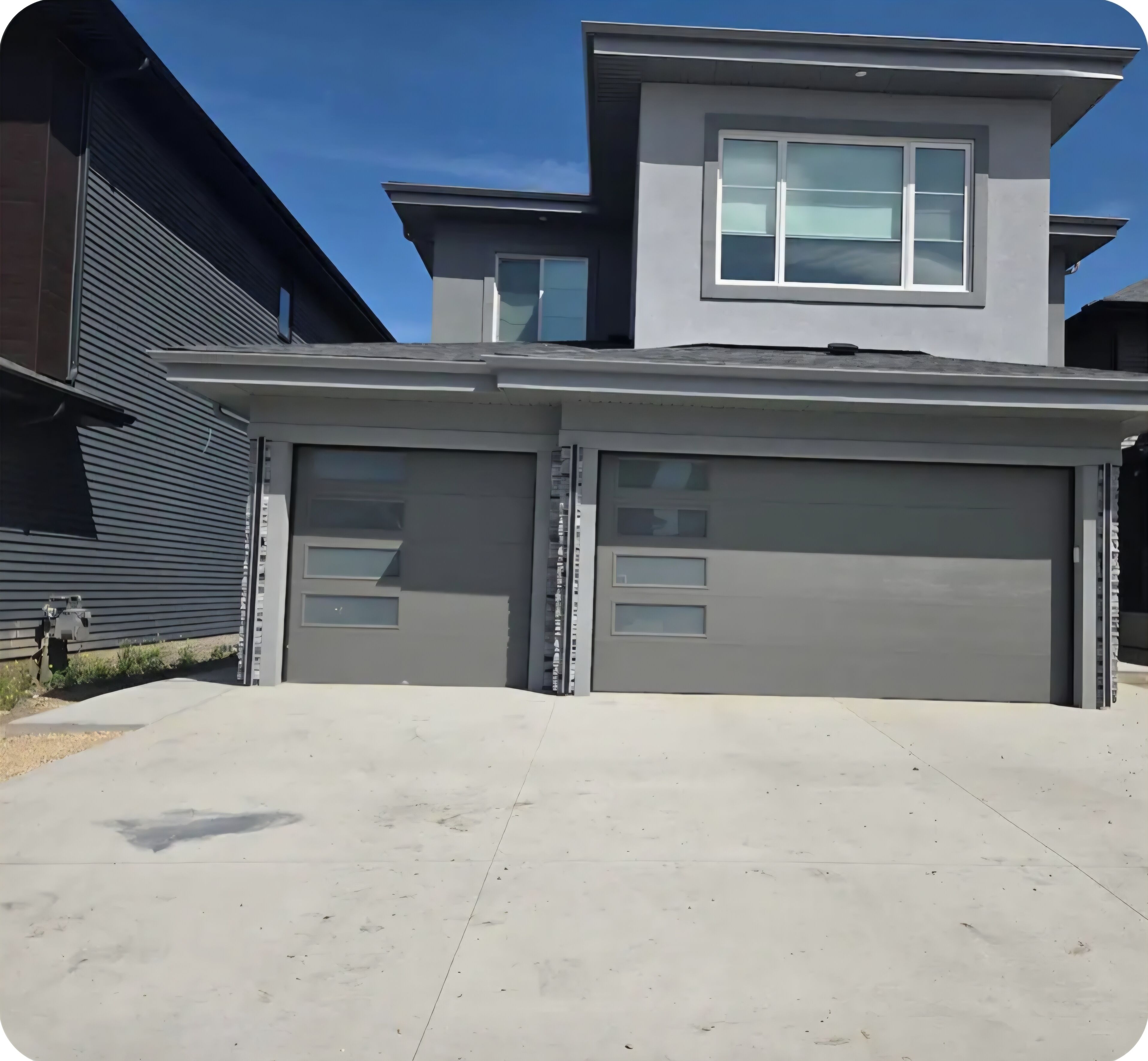 A modern two-story house with a garage and a driveway.