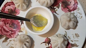 A plate with dumplings and a bowl of sauce. - Sea view villa (Shrivardhan)
