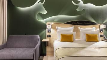 A modern hotel room with a bed, a nightstand, a lamp, and a chair.