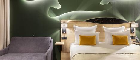 A modern hotel room with a bed, a nightstand, a lamp, and a chair.