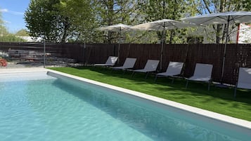 Seasonal outdoor pool, open 10:00 AM to 10:00 PM, pool umbrellas