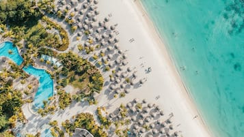 On the beach, white sand, beach cabanas, sun-loungers