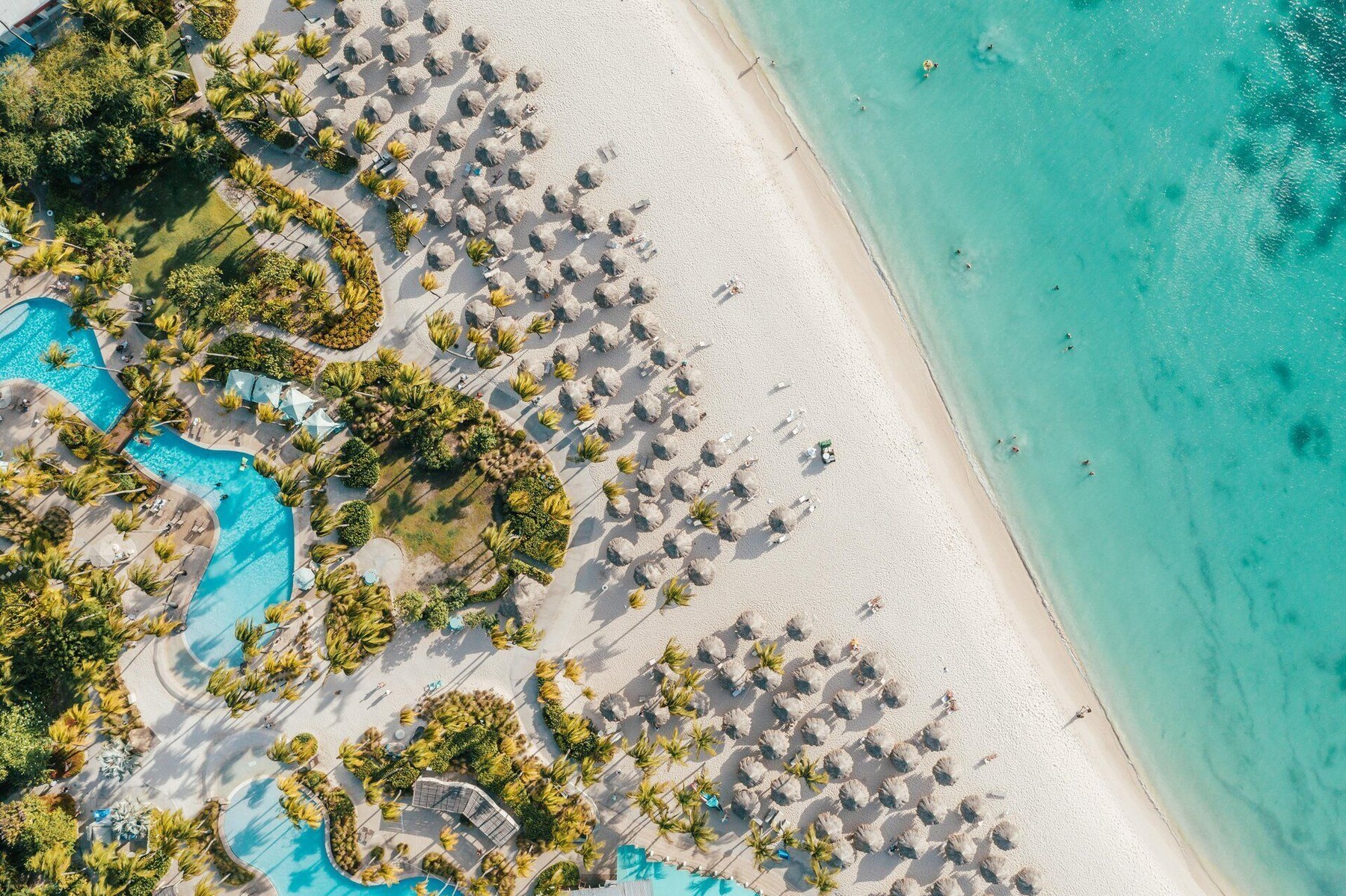 On the beach, white sand, beach cabanas, sun loungers