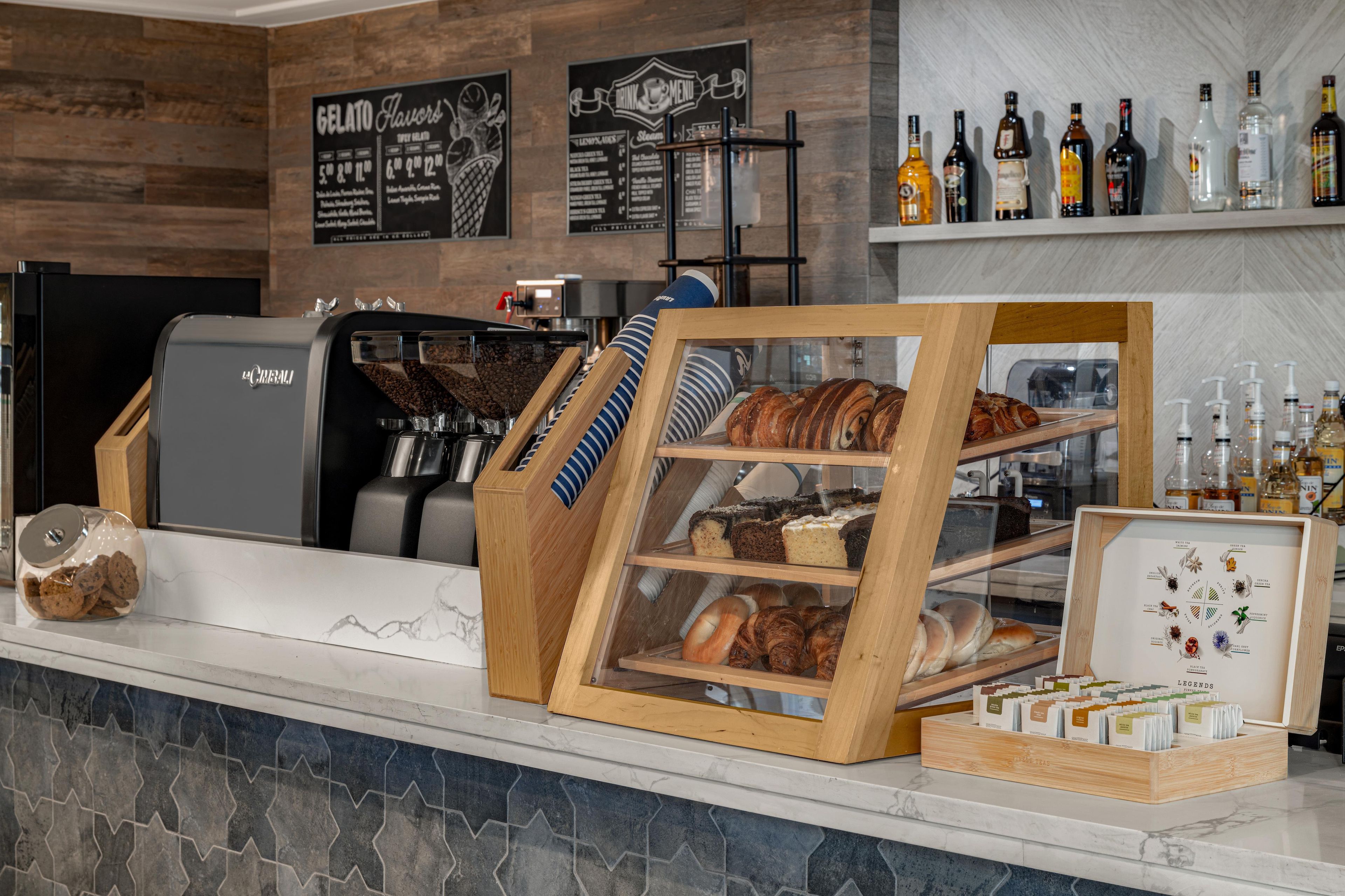 A bakery display with various baked goods and a coffee machine.