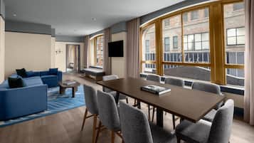 Deluxe Suite, 1 Bedroom | Living area | 55-inch Smart TV with cable channels, Netflix, books