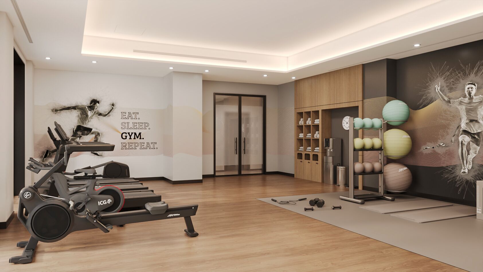 A modern gym with exercise equipment, a wall with motivational text, and a variety of fitness balls.