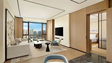 Family Suite, 1 King Bed | Living area | 55-inch TV with cable channels