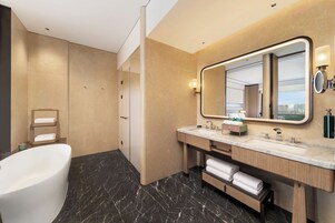 Deluxe Suite, 1 King Bed | Bathroom | Rainfall showerhead, hair dryer, bathrobes, slippers