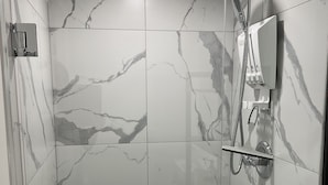 A modern shower with a handheld showerhead and a wall-mounted control panel. - Cozy, peaceful family-friendly neighborhood-steps away from the credit river (Mississauga)