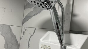 A modern shower with a handheld showerhead and a wall-mounted control panel. - Cozy, peaceful family-friendly neighborhood-steps away from the credit river (Mississauga)
