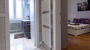 A modern interior with a hallway leading to a bedroom.