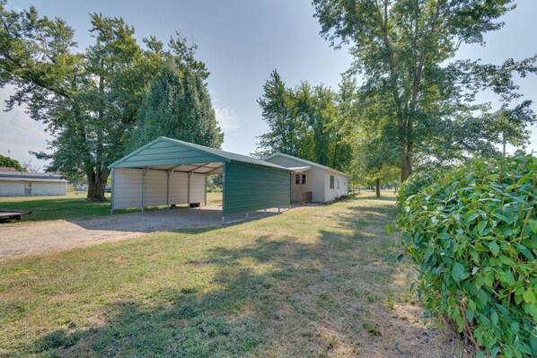 A single-story building with a green roof and a covered porch area.