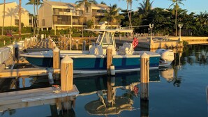 A marina with boats docked, wooden pilings, and a clear sky. - Charming Florida Keys townhome with boat slip in Tavernier 3 bedrooms available (Tavernier)