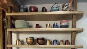 A kitchen shelf with various kitchenware and appliances. - Riva Bella Marine (Ouistreham)