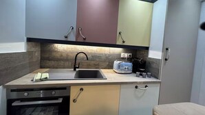 A compact kitchen with a sink, toaster, and coffee maker. - Riva Bella Marine (Ouistreham)