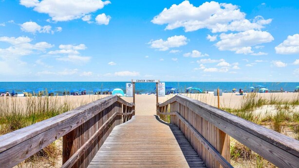 A wooden boardwalk leading to a beach with a sign reading "CENTER STREET". - Beachside Colony Resort Unit 222A (Tybee Island)