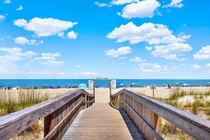 A wooden boardwalk leading to a beach with a sign reading 'CENTER STREET'. - Beachside Colony Resort Unit 222A (Tybee Island)