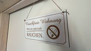 A sign in a room indicating no smoking is allowed.