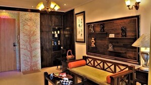 A traditional interior with a wooden bench, a chandelier, and wall-mounted shelves. - Boutique Themed Studio - Kuching Riverine Diamond (Kuching)