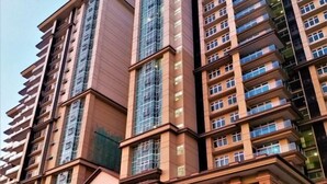 A multi-story residential building with a modern architectural design, featuring balconies and large windows. - Boutique Themed Studio - Kuching Riverine Diamond (Kuching)