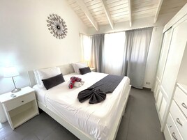 Exclusive Apartment, Ocean View | Down comforters, in-room safe, individually decorated